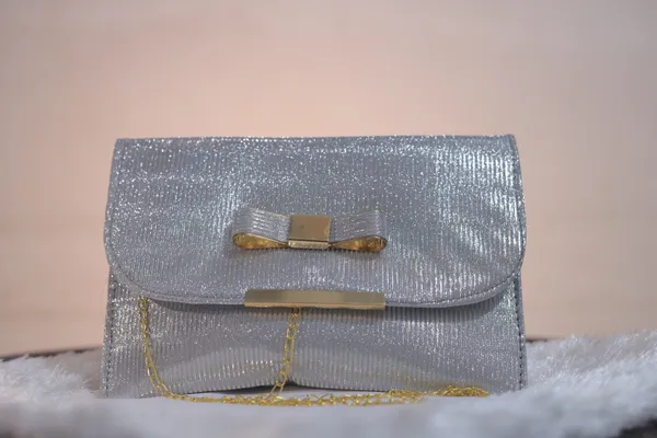 Elegant_Silver_Shimmer_Evening_Clutch_With_Bow_Detail._Buy_1_Get_1_Free_Colour_May_Be_Varey