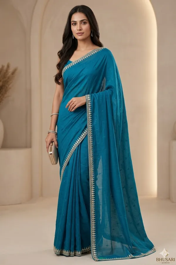 Blue_Georgette_Saree_With_Embellished_Border_And_Blouse_Piece
