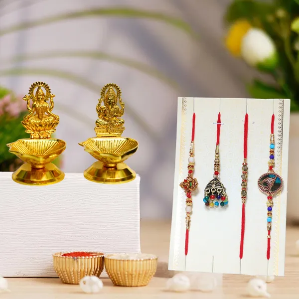 Chhariya_Crafts_Bhaiya_Bhabhi_Bhaiya_Bhabhi_Rakhi_Combo_Gift_Set_Assorted,_Gold_Finish,_Jute,_Pearl,_Plastic_(PVC),_Zardosi_Rakhi,_Showpiece,_Lumba,_Chawal_Roli_Pack__Set_(2_Metal_Diya_Showpieces,_1_Chawal_Roli_Pack,_1_Designer_Lumba,_3_Designer_Rakhi)