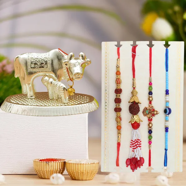 Chhariya_Crafts_Bhaiya_Bhabhi_Bhaiya_Bhabhi_Rakhi_Combo_Gift_Set_Assorted,_Gold_Finish,_Jute,_Pearl,_Plastic_(PVC),_Zardosi_Rakhi,_Showpiece,_Lumba,_Chawal_Roli_Pack__Set_(1_Metal_Cow_Showpieces,_1_Chawal_Roli_Pack,_1_Designer_Lumba,_3_Designer_Rakhi)