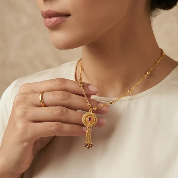 Gold_Toned_Chain_Necklace_With_Decorative_Pendant