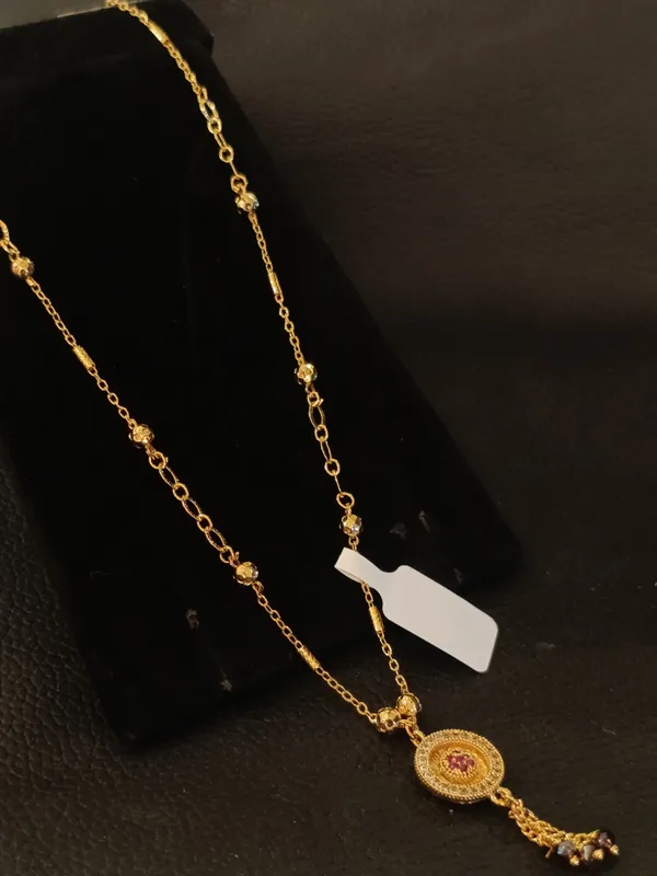 Gold_Toned_Chain_Necklace_With_Decorative_Pendant