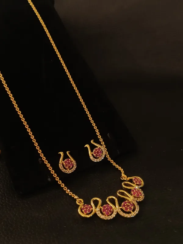 Ruby_Studded_Peacock_Design_Gold_Toned_Necklace_Set_With_Matching_Earrings