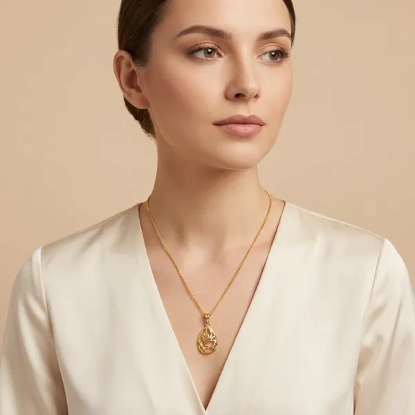 Elegant_Gold_Toned_Teardrop_Pendant_Necklace_With_Intricate_Filigree_Design