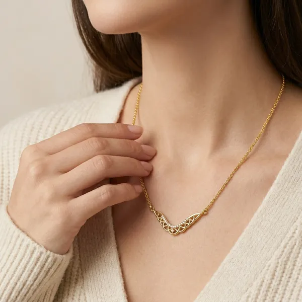 Elegant_Gold_Toned_Necklace_With_Intricate_Cutwork_Pendant