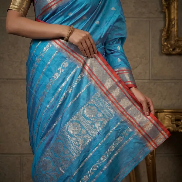 Bishnupuri_Paisely_Nakshi_Butta_Work_Pure_Katan_Silk_Saree_In_Turquoise_Blue_Portland_Orange_And_Matt_Gold