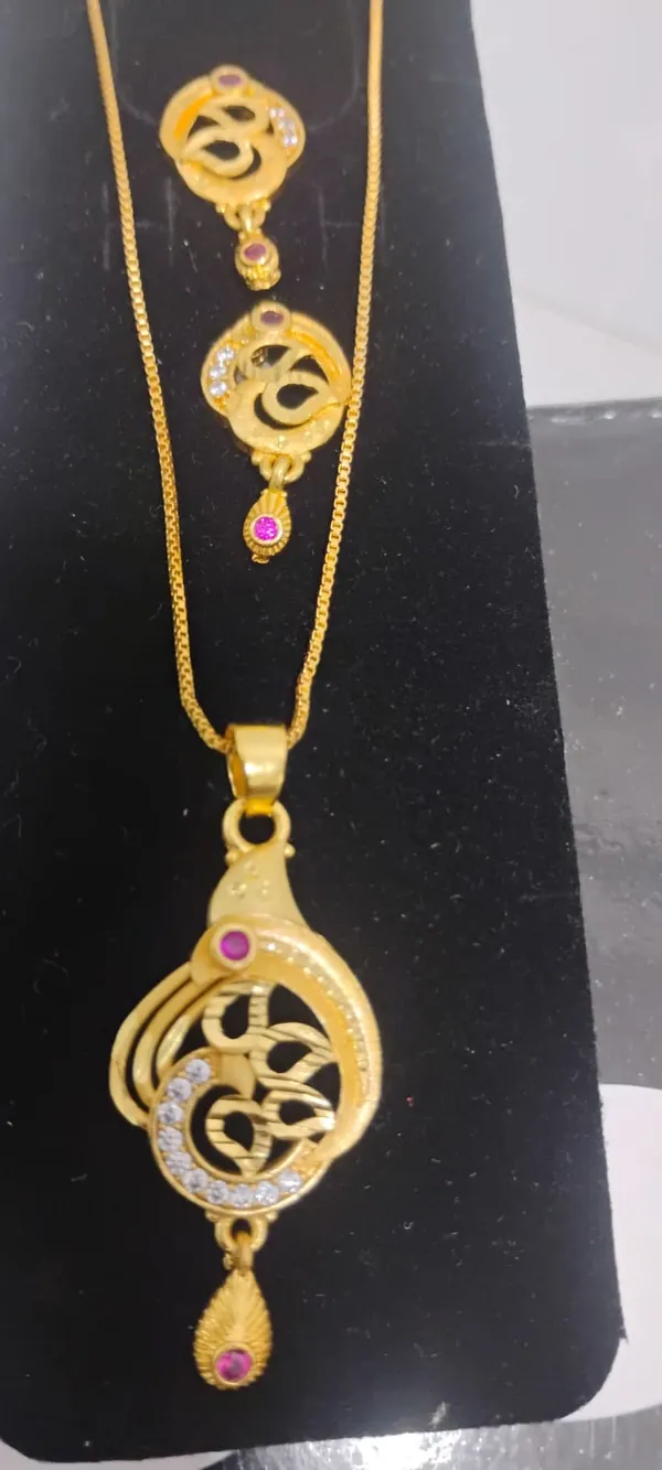 Traditional_Gold_Toned_Om_Pendant_Necklace_And_Earrings_Set_With_Purple_Stone_Accents