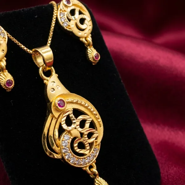Traditional_Gold_Toned_Om_Pendant_Necklace_And_Earrings_Set_With_Purple_Stone_Accents
