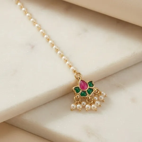 Traditional_Golden_Maang_Tikka_with_Pink_and_Green_Stones_and_Pearl_Chain