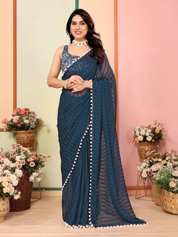 Dark_Teal_Saree_With_White_Pom-Pom_Border_And_Embroidered_Blouse