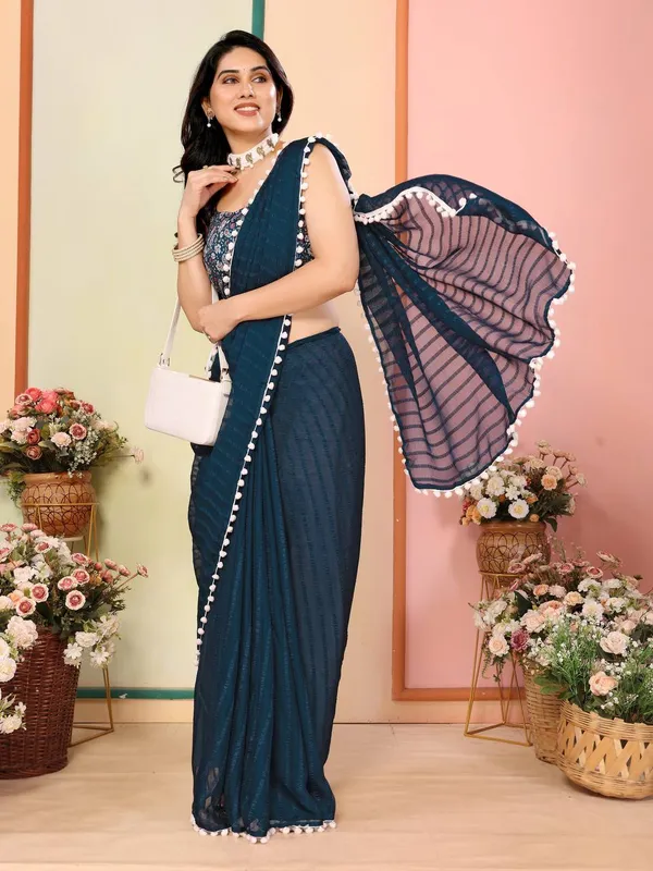 Dark_Teal_Saree_With_White_Pom-Pom_Border_And_Embroidered_Blouse