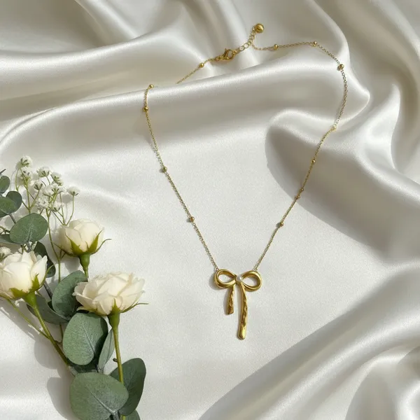 Gold_Pearl_Center_Bow_Pendant