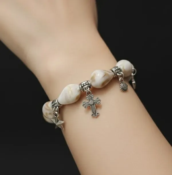 Pearl_Charm_Bracelet_With_Silver_Cross_And_Star_Pendants