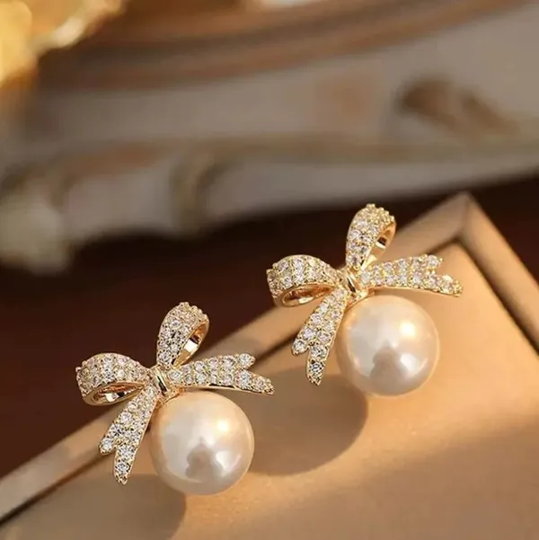 Elegant_Pearl_Drop_Earrings_With_Crystal_Bow_Design