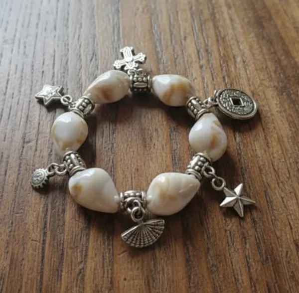 Pearl_Charm_Bracelet_With_Silver_Cross_And_Star_Pendants