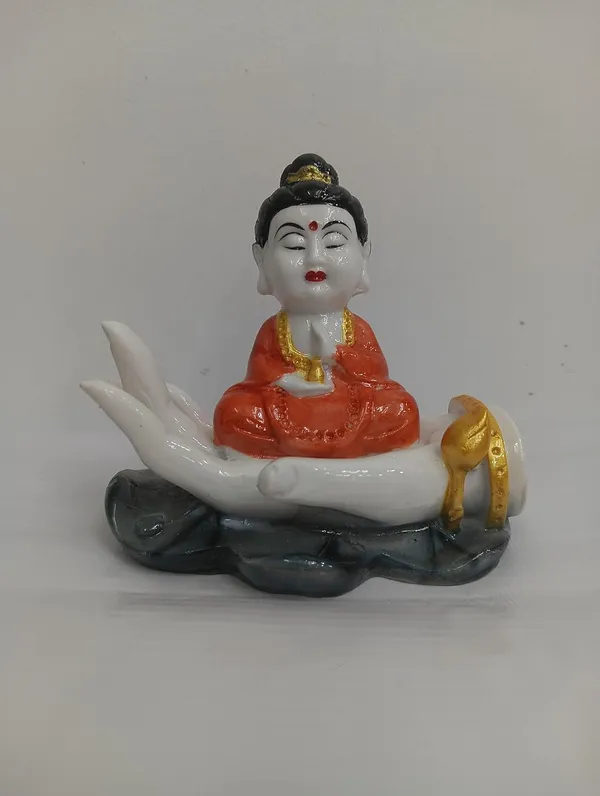 White_Buddha_Figurine_On_Palm