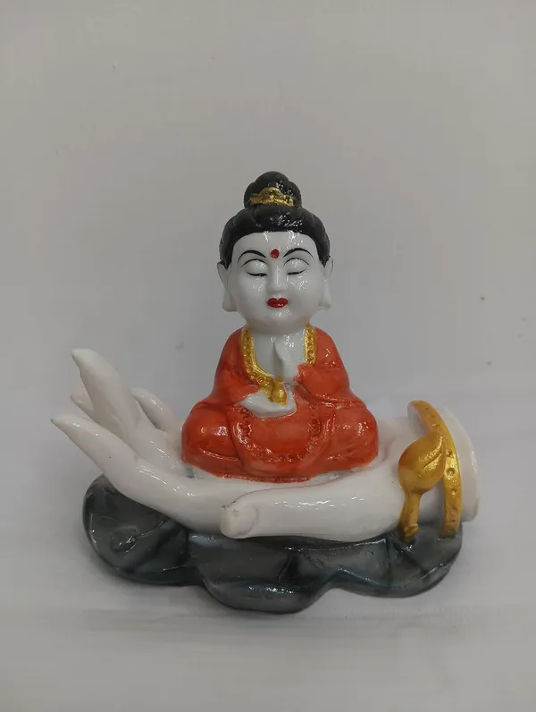 White_Buddha_Figurine_On_Palm