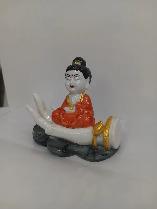 White_Buddha_Figurine_On_Palm