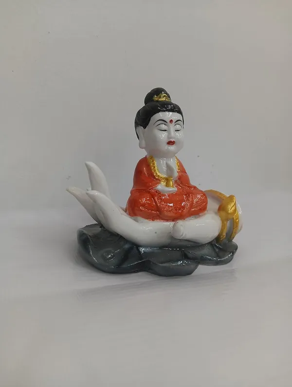 White_Buddha_Figurine_On_Palm