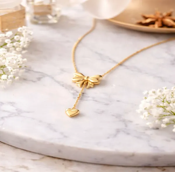 Elegant_Gold-Toned_Bow_Heart_Pendant_Necklace