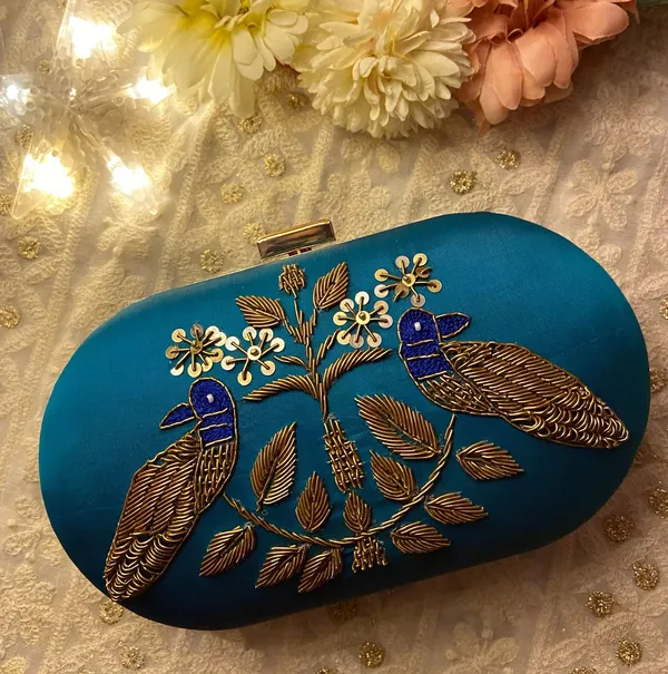 Blue_Silk_Base_And_Metal_Frame_And_Zardosi_Work_Embroidered_Bag_For_Women