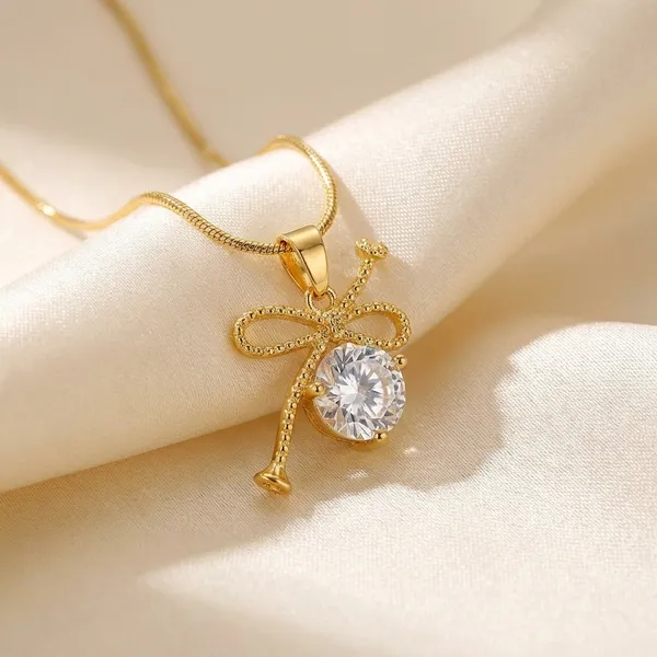 Gold_Toned_Brass_Ribbon_Bow_Pendant_Necklace_With_Clear_Crystal_Stone