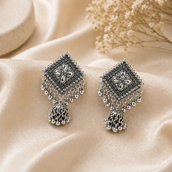 Silver_Toned_Brass_Jhumka_Earrings_With_Floral_Design_And_Tassel_Drops