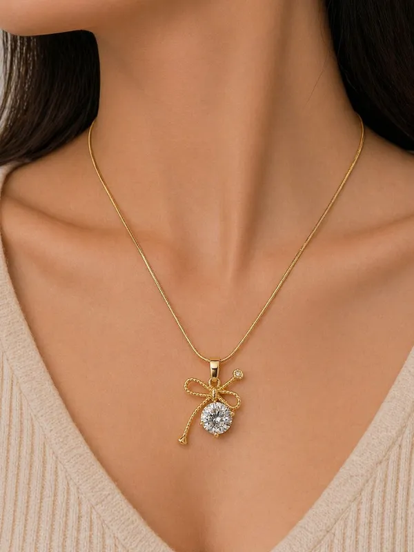 Gold_Toned_Brass_Ribbon_Bow_Pendant_Necklace_With_Clear_Crystal_Stone
