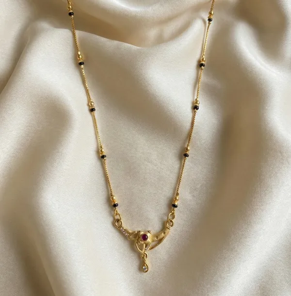 Stylish_Gold_Plated_Mangalsutra_For_Women_Curved_Pendant_Design_Simple_Black_Beads_Necklace