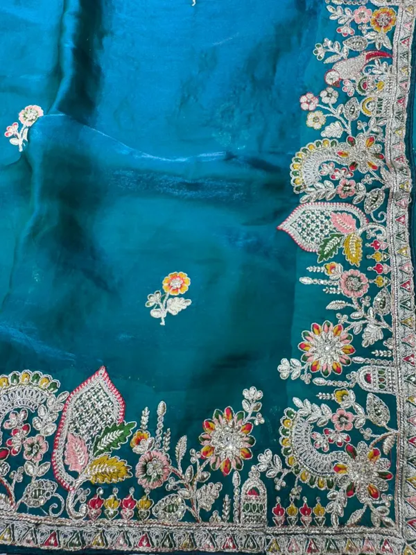 Turquoise_Silk_Saree_With_Intricate_Floral_Embroidery_And_Zari_Work