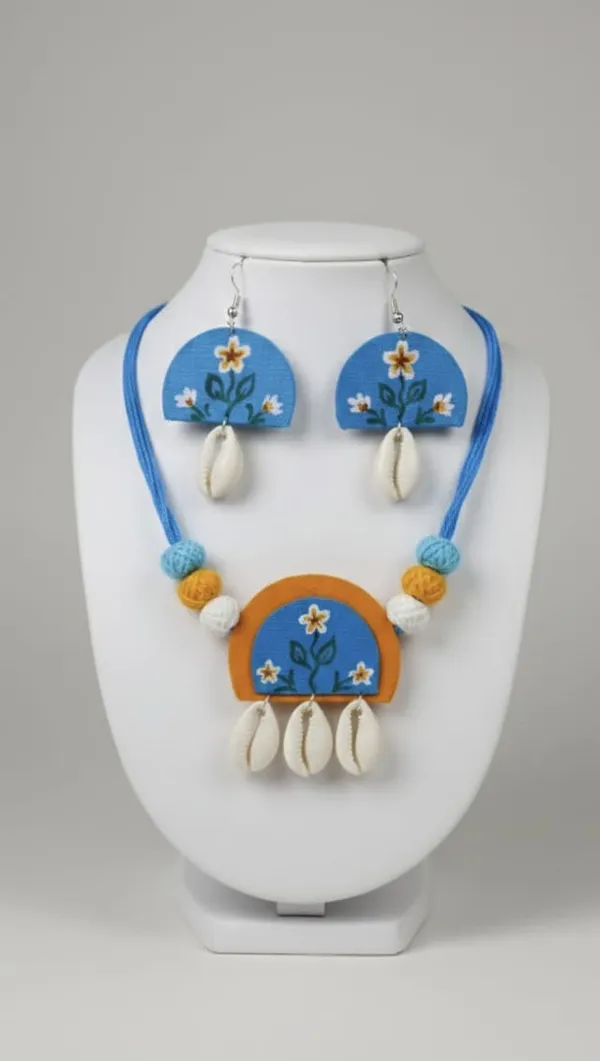 Handcrafted_Blue_Terracotta_Necklace_And_Earring_Set_With_Floral_Design_And_Cowrie_Shell_Drops