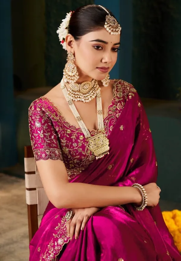 Elegant_Magenta_Silk_Saree_With_Embroidered_Blouse_And_Traditional_Gold_Jewelry_Set