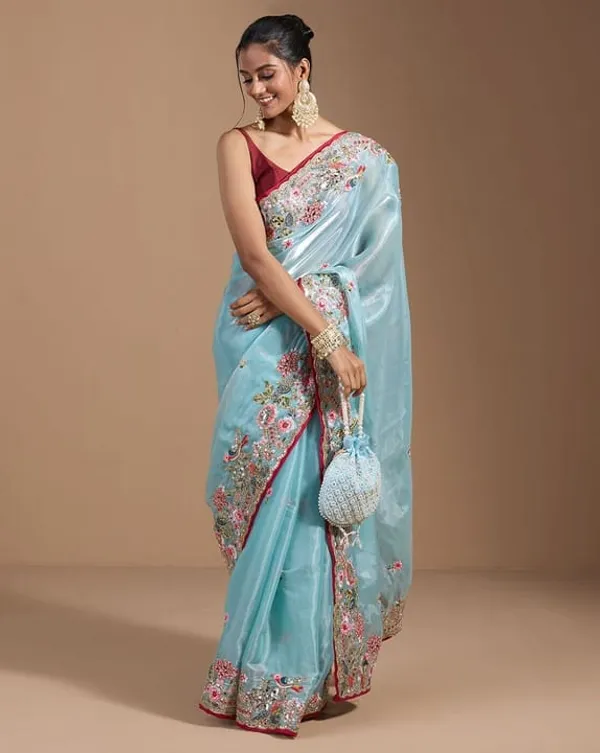 Sky_Blue_Embroidered_Organza_Saree_With_Floral_Border_And_Red_Blouse
