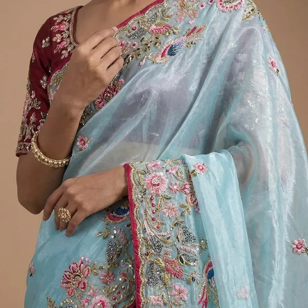 Sky_Blue_Embroidered_Organza_Saree_With_Floral_Border_And_Red_Blouse