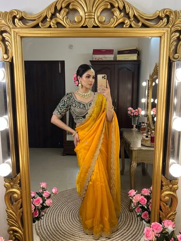 Yellow_Organza_Silk_Saree_With_Embroidered_Blouse_And_Golden_Border