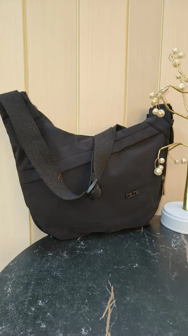Stylish_Moon_Sling_Bags_Premium_Nylon_Lycra_Imported_Material_super_light_weight_apt_for_college,_office,_travel_or_outings_with_multiple_sturdy_zip_compartments_Black