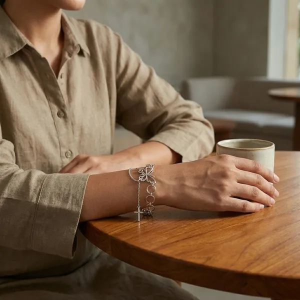 Elegant_Silver-Toned_Chain_Bracelet_With_Infinity_Loop_And_Cross_Pendant