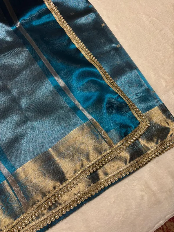 MATALLIC_SKY_BLUE_TISSUE_SILK_SAREE_WITH_HEAVY_JARKAN_LACE_WORK