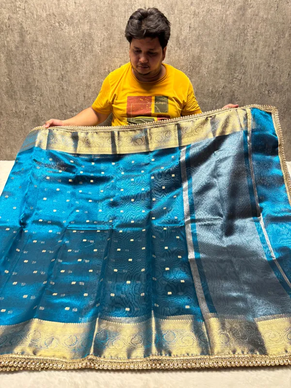 MATALLIC_SKY_BLUE_TISSUE_SILK_SAREE_WITH_HEAVY_JARKAN_LACE_WORK