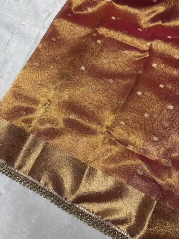 MATALLIC_PEACH_TISSUE_SILK_SAREE_WITH_HEAVY_JARKAN_LACE_WORK