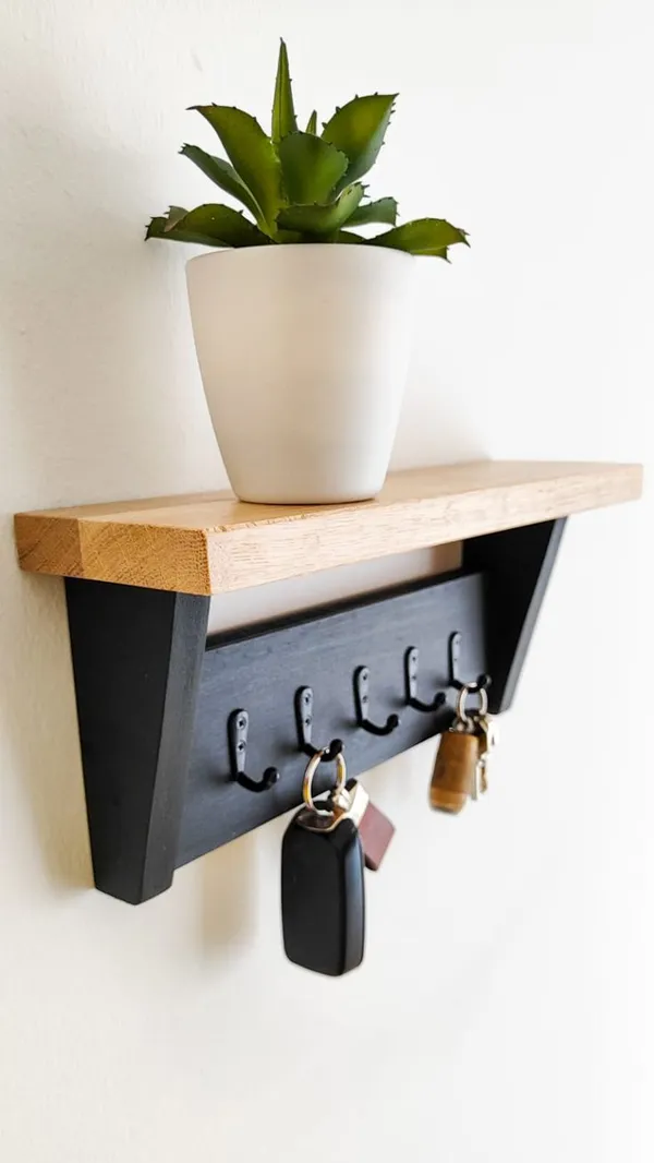 Wall_Mounted_Wooden_Shelf_With_Metal_Key_Hooks_And_Decorative_Planter