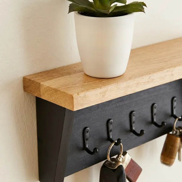 Wall_Mounted_Wooden_Shelf_With_Metal_Key_Hooks_And_Decorative_Planter