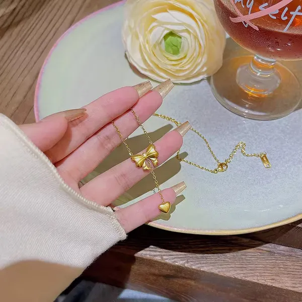 Elegant_Gold_Bow_Pendant_Necklace_with_Heart_Drop_Charm