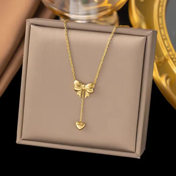 Elegant_Gold_Bow_Pendant_Necklace_with_Heart_Drop_Charm
