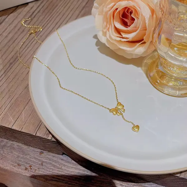 Elegant_Gold_Bow_Pendant_Necklace_with_Heart_Drop_Charm
