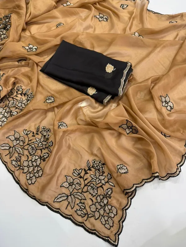 RIDHI_SAREE_✨_Premium_Soft_Chiffon_Saree_✨__Grace_your_look_with_this_elegant_golden_beige_organza_saree_featuring_beautiful_floral_embroidery_work_with_a_stylish_black_outline_border._The_lightweight_and_soft_fabric_gives_a_rich,_classy,_and_graceful_appearance,_perfect_for_festive_occasions,_parties,_weddings,_and_special_events._Paired_with_a_matching_black_embroidered_blouse_piece,_this_saree_creates_a_stunning_traditional_yet_modern_look._