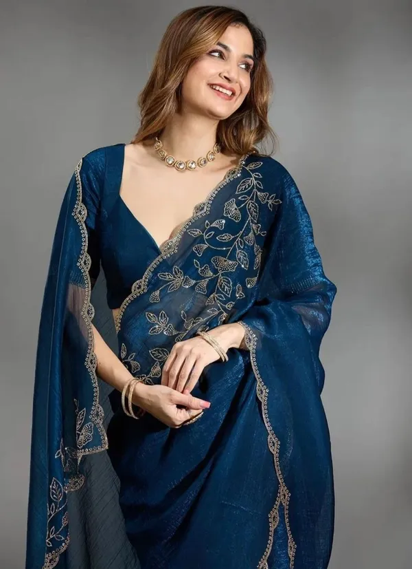 Elevate_your_ethnic_wardrobe_with_this_stunning_Navy_Blue_Designer_Saree_crafted_for_timeless_elegance._Featuring_delicate_floral_embroidery_work_on_the_border_and_pallu,_this_saree_blends_grace_with_modern_sophistication._The_rich_texture_and_shimmering_finish_add_a_luxurious_charm,_making_it_perfect_for_weddings,_festive_occasions,_parties,_and_special_celebrations._Paired_with_a_stylish_matching_blouse,_this_saree_gives_a_classy_and_graceful_look_effortlessly._