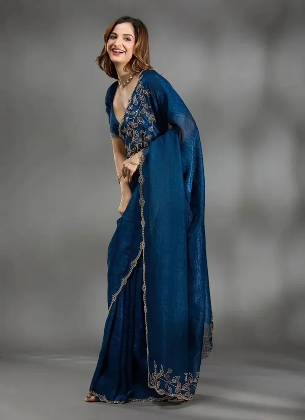 Elevate_your_ethnic_wardrobe_with_this_stunning_Navy_Blue_Designer_Saree_crafted_for_timeless_elegance._Featuring_delicate_floral_embroidery_work_on_the_border_and_pallu,_this_saree_blends_grace_with_modern_sophistication._The_rich_texture_and_shimmering_finish_add_a_luxurious_charm,_making_it_perfect_for_weddings,_festive_occasions,_parties,_and_special_celebrations._Paired_with_a_stylish_matching_blouse,_this_saree_gives_a_classy_and_graceful_look_effortlessly._
