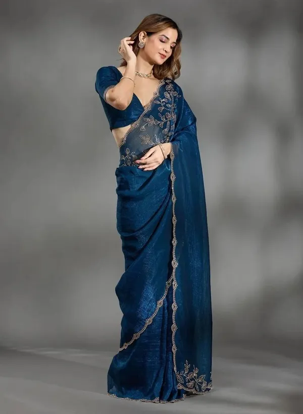 Elevate_your_ethnic_wardrobe_with_this_stunning_Navy_Blue_Designer_Saree_crafted_for_timeless_elegance._Featuring_delicate_floral_embroidery_work_on_the_border_and_pallu,_this_saree_blends_grace_with_modern_sophistication._The_rich_texture_and_shimmering_finish_add_a_luxurious_charm,_making_it_perfect_for_weddings,_festive_occasions,_parties,_and_special_celebrations._Paired_with_a_stylish_matching_blouse,_this_saree_gives_a_classy_and_graceful_look_effortlessly._