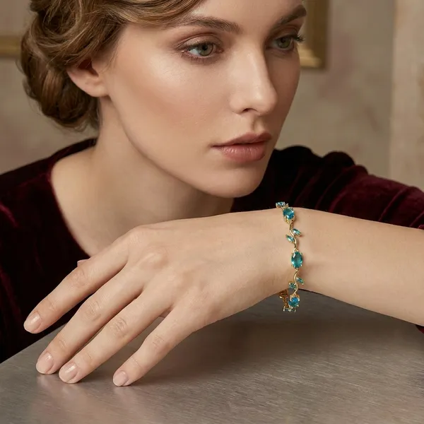Gold-Tone_Bracelet_With_Blue_Oval_Gemstones